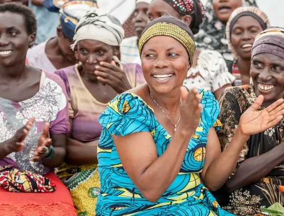 Image of diverse group of African women working together and supporting each other in a community setting.