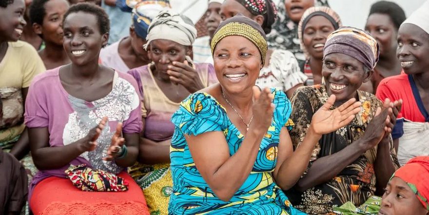 Image of diverse group of African women working together and supporting each other in a community setting.