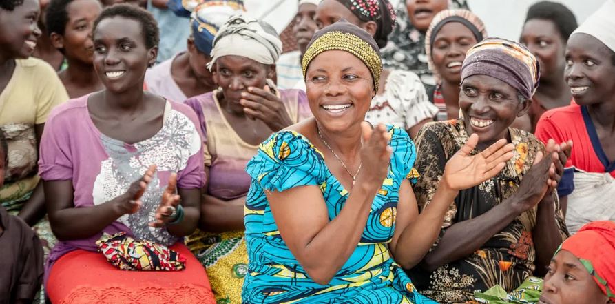 Image of diverse group of African women working together and supporting each other in a community setting.