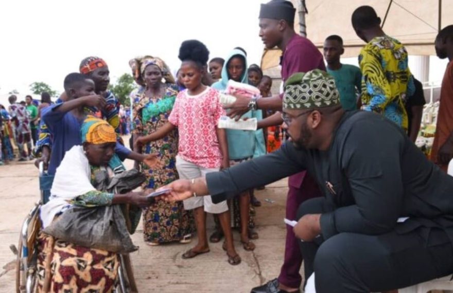 Honourable Abdulrasheed Kashamu distributing cash and food items to a crowd at his residence in Ijebu Igbo during the Eid-el Kabir celebration.