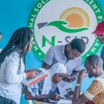 Image of a group of young Nigerian volunteers participating in the N-Power initiative, receiving training and skills development opportunities.