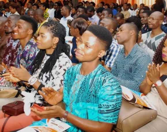 Nigerian youth engaging in discussions about skill development and innovation at a seminar.