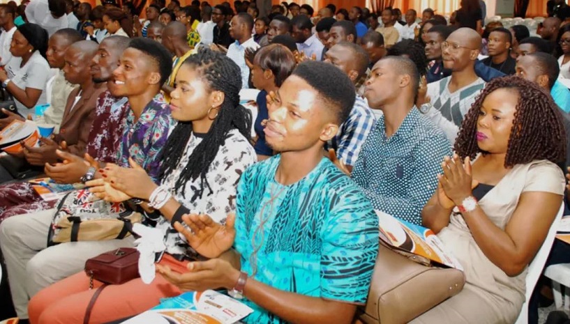 Nigerian youth engaging in discussions about skill development and innovation at a seminar.