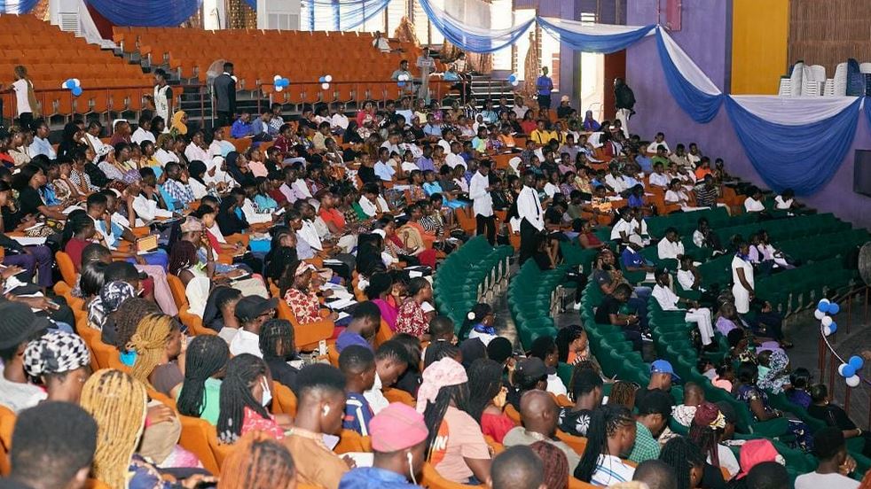 A large group of Nigerian students gathered at a summit, engaging in discussions about combating drug abuse.