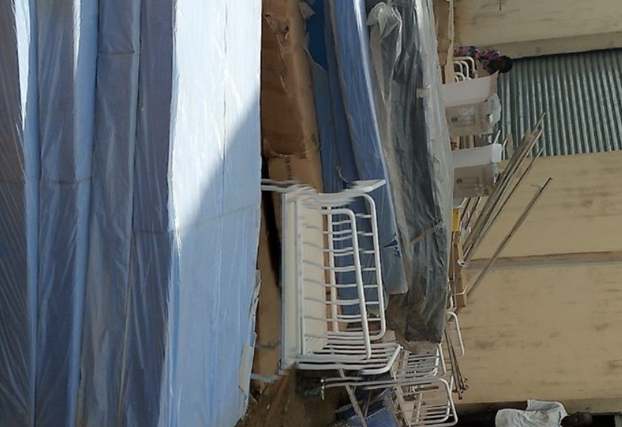 Nigerian healthcare workers in a hospital setting, discussing patient care and medical treatment