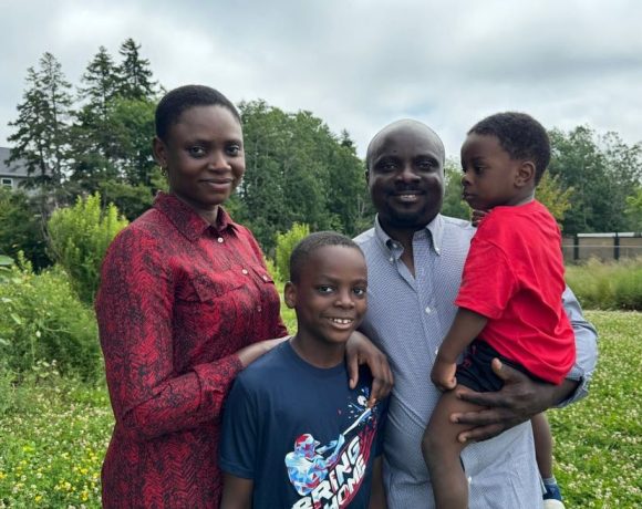 A photo of a distressed family with a Canadian flag in the background, symbolizing the challenges faced by immigrants dealing with fraudulent documentation issues.