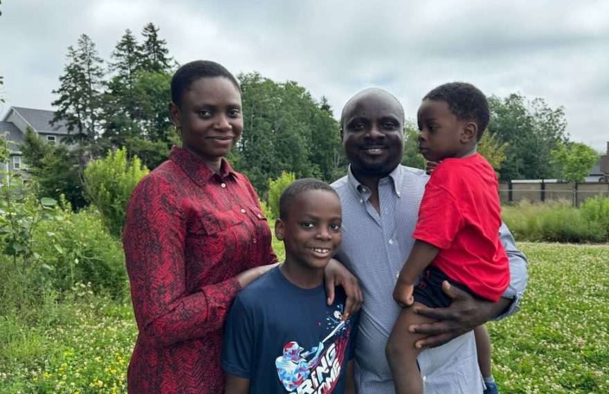 A photo of a distressed family with a Canadian flag in the background, symbolizing the challenges faced by immigrants dealing with fraudulent documentation issues.