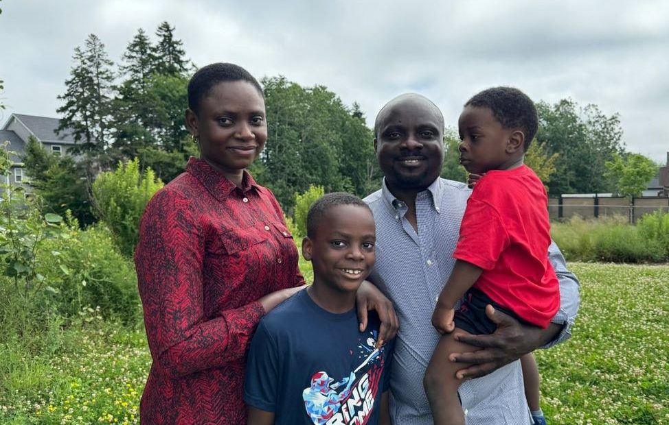 A photo of a distressed family with a Canadian flag in the background, symbolizing the challenges faced by immigrants dealing with fraudulent documentation issues.