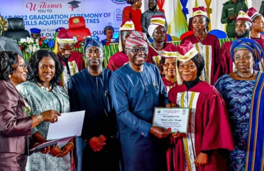 A group of skill acquisition graduates in Lagos holding their start-up packs at the graduation ceremony.