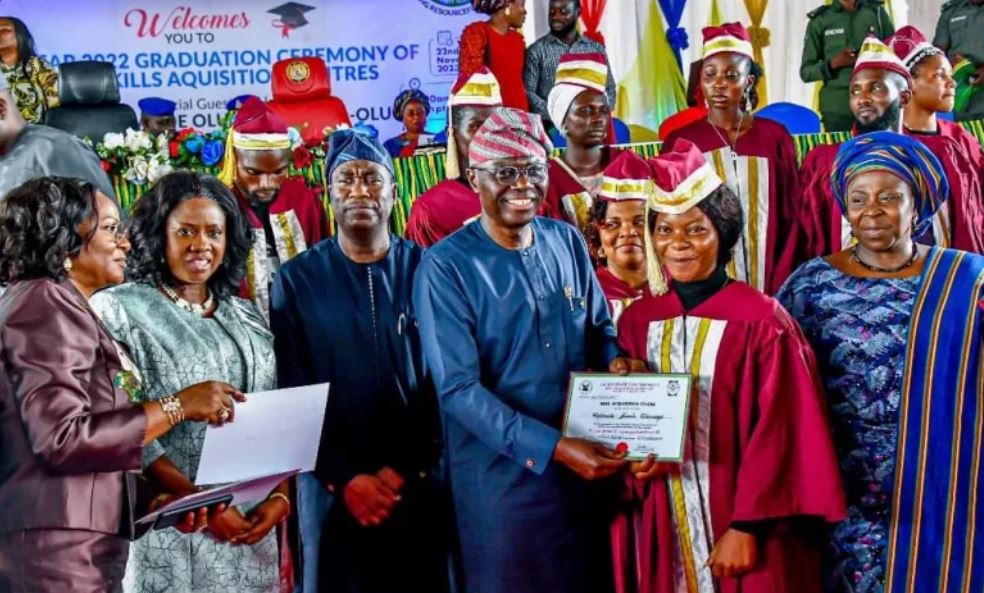 A group of skill acquisition graduates in Lagos holding their start-up packs at the graduation ceremony.