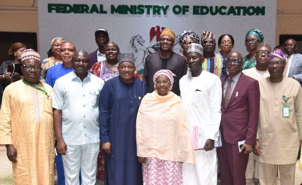 A group of Nigerian teachers in a classroom, engaging with students.