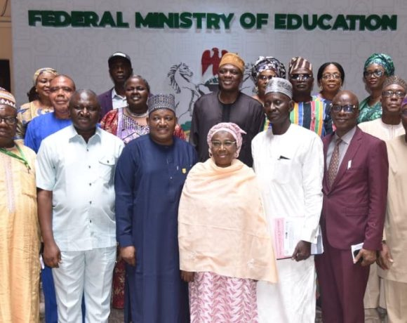 A group of Nigerian teachers in a classroom, engaging with students.