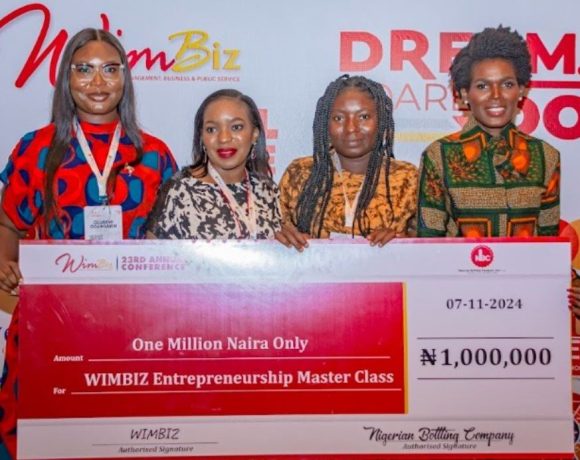 A Nigerian female entrepreneur receives a grant from NBC in collaboration with WIMBIZ to boost her business at the annual WIMBIZ conference.