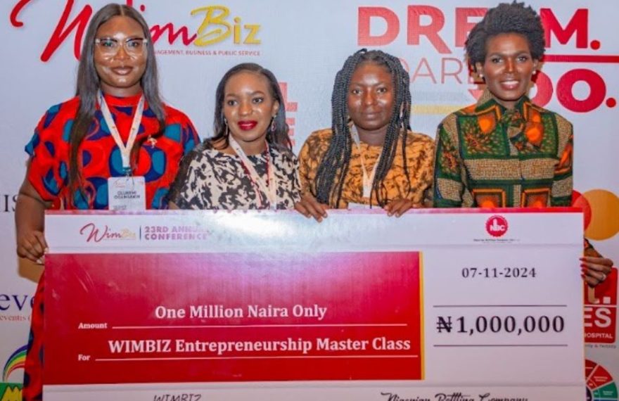 A Nigerian female entrepreneur receives a grant from NBC in collaboration with WIMBIZ to boost her business at the annual WIMBIZ conference.