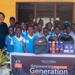 FXCG team presenting school bags and stationery to pupils of Kuramo Primary School, engaging in interactive sessions with teachers and students.