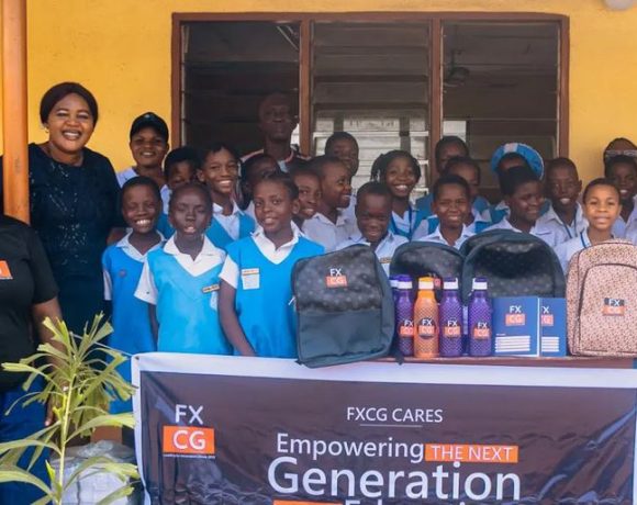 FXCG team presenting school bags and stationery to pupils of Kuramo Primary School, engaging in interactive sessions with teachers and students.